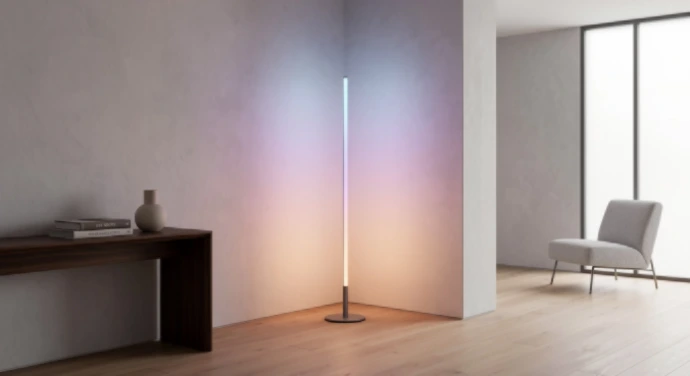 Minimalist RGB LED corner floor lamp providing cinematic ambient lighting in a living room.